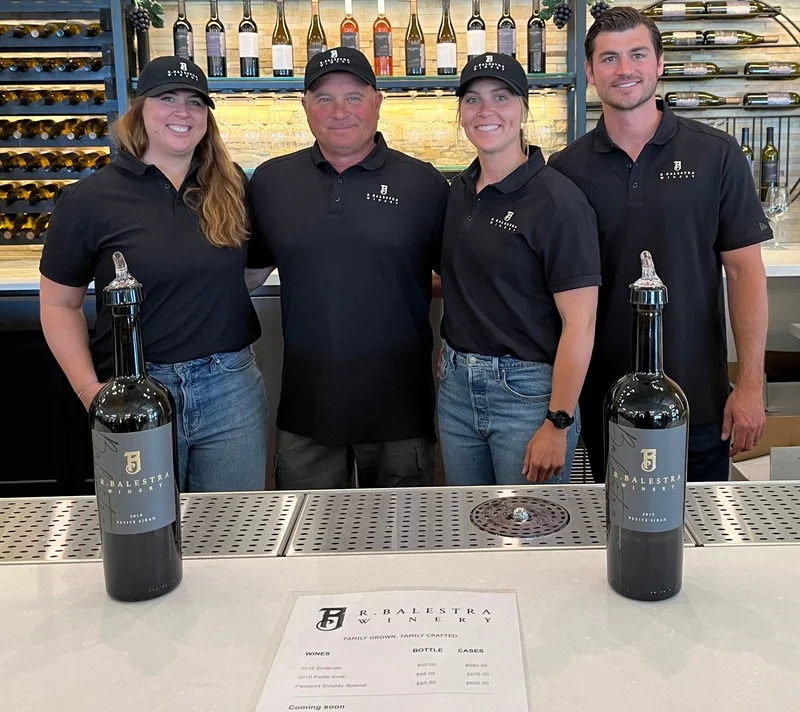 Balestra Family Wine team presenting wine bottles at SV Filing Station.